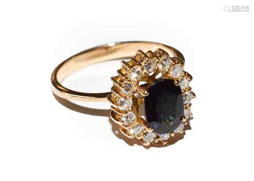 A sapphire and diamond cluster ring, the oval cut sapphire w...