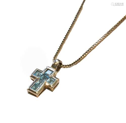 An 18 carat white gold blue topaz cross pendant on an 18 car...