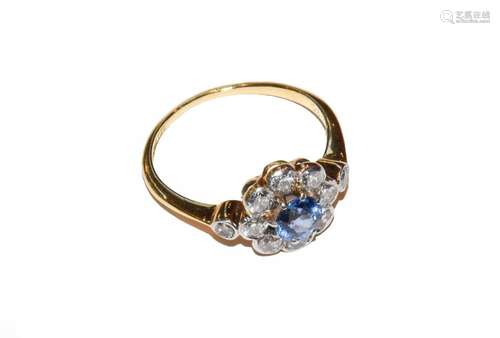 A blue topaz and diamond cluster ring, stamped 18CT&PT, ...