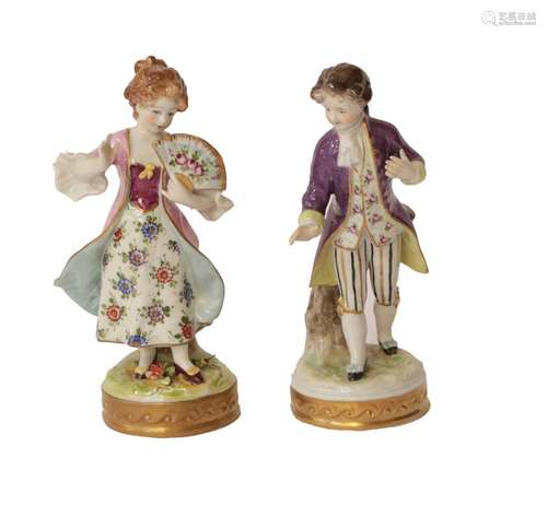 A pair of 20th century Sitzendorf figures in floral costume,...