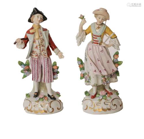 A pair of 20th century Sitzendorf figures, the lady in a yel...