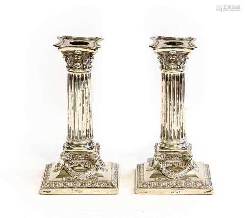 A pair of late Victorian silver candlesticks as Corinthian c...