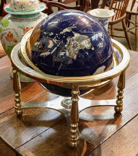 A modern table globe, the countries made up from different h...