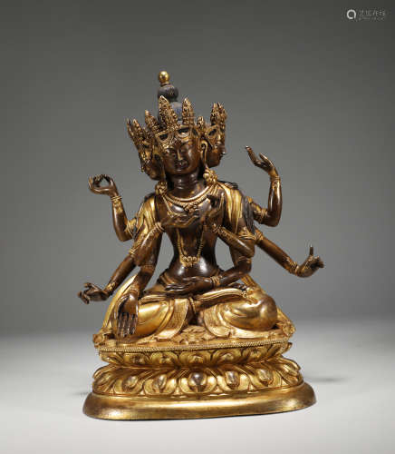 A bronze gilt Buddha with eight arms and three faces from th...