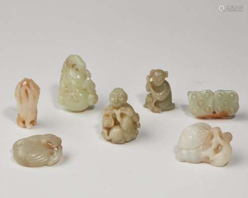 Seven Chinese jade and hardstone figural and fruit carvings