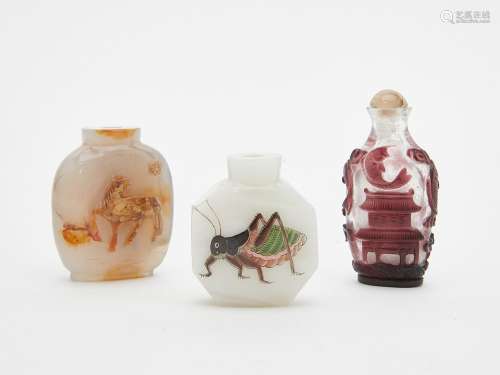 Three Chinese hardstone and glass snuff bottles