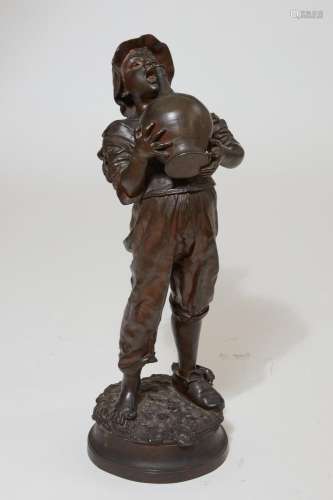 An Italian patinated bronze model of a young boy with a wine...