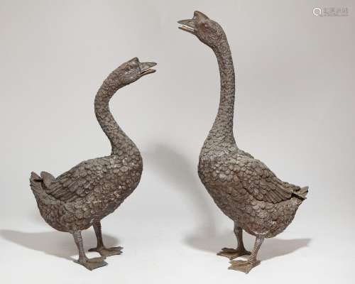 A pair of life size patinated metal models of geese, 20th ce...