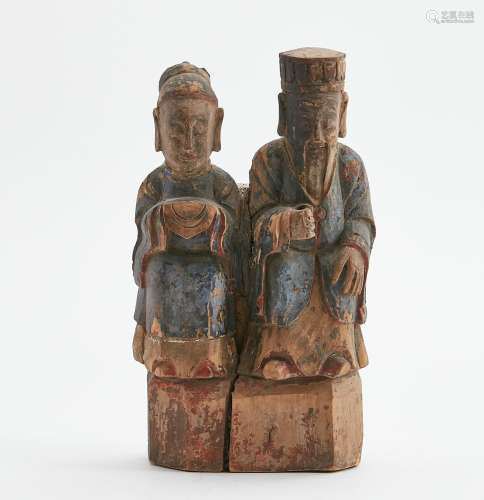 A Chinese polychrome decorated wood group of male and female...