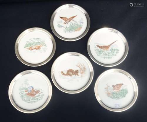 SIX PORCELAIN COASTERS WITH SILVER RIM