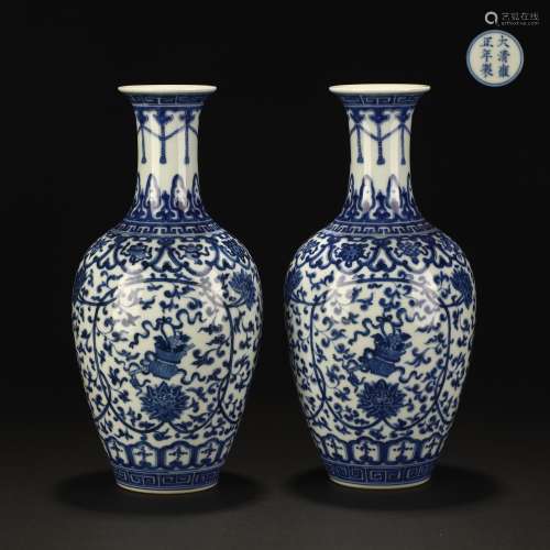 A pair of blue and white lotus bottles with wrapped branches