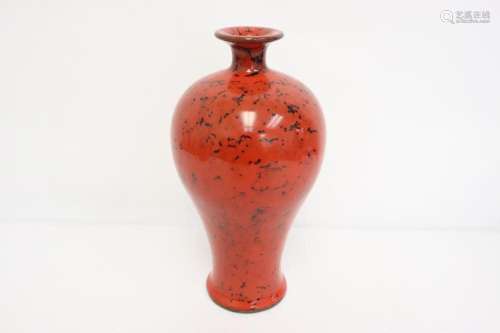 A red glazed porcelain vase