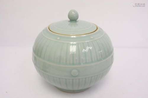 A light green glazed porcelain covered jar