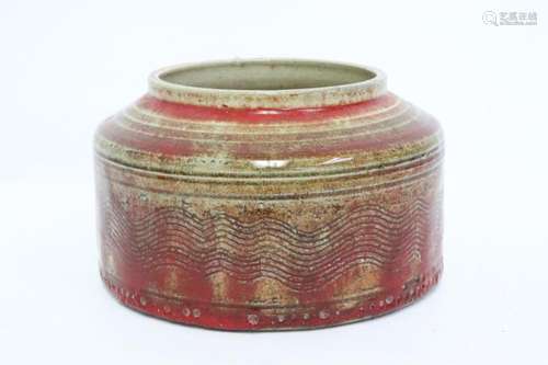 A red glazed pottery jar