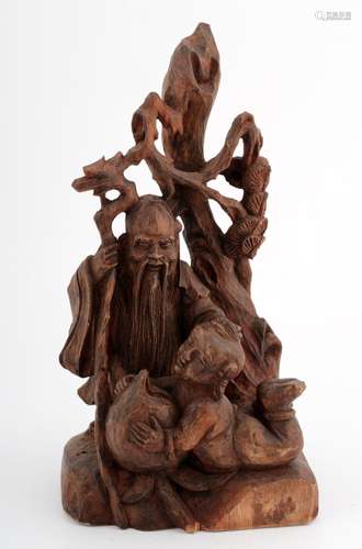 A CHINESE ZHANGMU WOOD FIGURE OF AN OLD MAN AND A CHILDREN