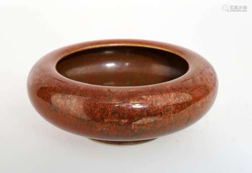 A COWPEA RED GLAZE PORCELAIN BRUSHWASHER.THE BASE MARKED WIT...