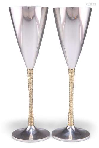 A PAIR OF ELIZABETH II PARCEL-GILT SILVER GOBLETS, by Stuart...