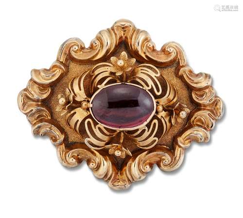 A CARBUNCLE GARNET BROOCH, an oval garnet within a border of...