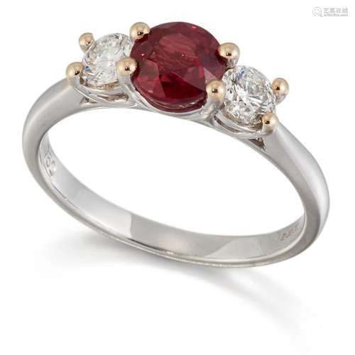 AN 18 CARAT WHITE GOLD RUBY AND DIAMOND THREE STONE RING, a ...