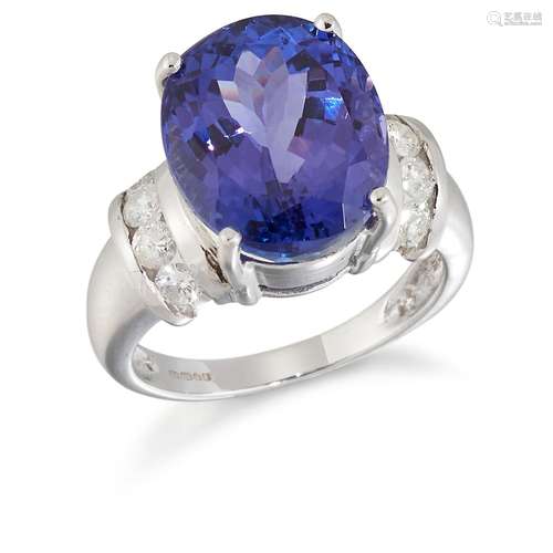 AN 18 CARAT WHITE GOLD TANZANITE AND DIAMOND RING, an oval-c...