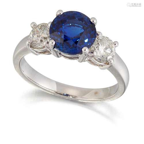 AN 18 CARAT WHITE GOLD SAPPHIRE AND DIAMOND THREE STONE RING...