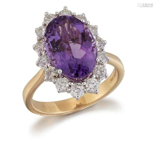 AN 18 CARAT GOLD AMETHYST AND DIAMOND CLUSTER RING, an oval-...