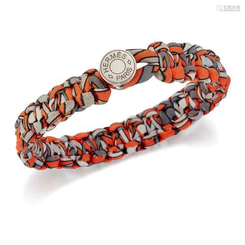 HERMÈS - A SILK TWILL KID BRACELET, of braided orange and gr...