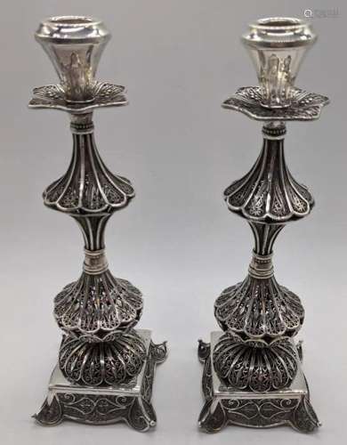 A pair of Middle Eastern silver filigree candlesticks,