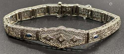 A 14ct white gold bracelet, mounted with 3 diamonds and