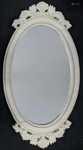 An oval white painted contemporary wall mirror, H.94cm