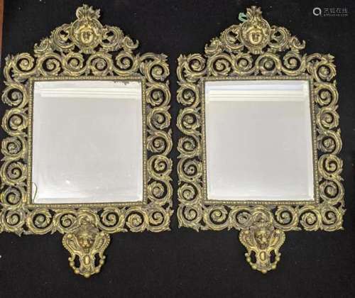 A pair of brass wall mirrors, bevelled plate glass,