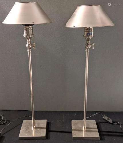 A pair of metal industrial style adjustable table lamps