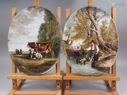 A pair of painted oval porcelain panels, decorated landscape...