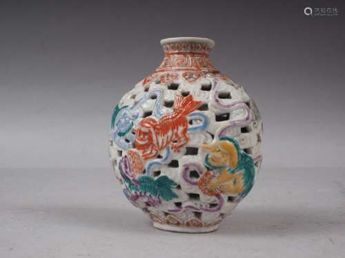A Chinese porcelain pierced and relief decorated snuff bottl...