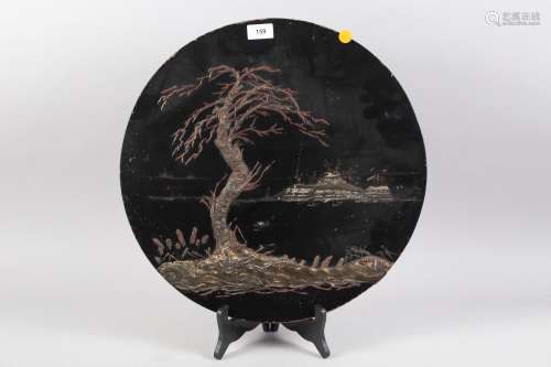 A Japanese circular lacquered landscape panel, 18 dia