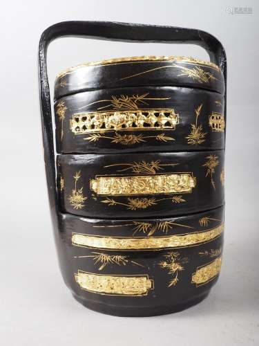 A Chinese black and gilt lacquered three-tier wedding basket...