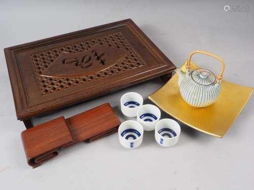 A Japanese carved hardwood tea tray, a scrolled hardwood sta...