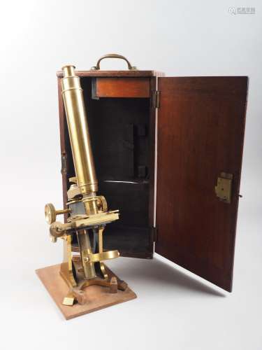 A 19th century brass monocular microscope with two lenses, i...