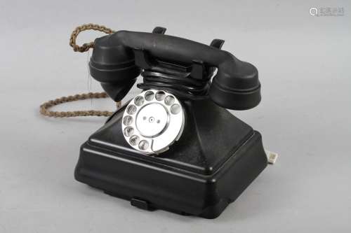 A black cased rotary telephone, No 1/232