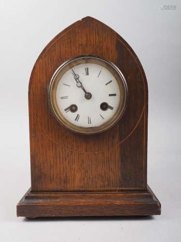 An early 20th century oak arch top mantel clock with line in...