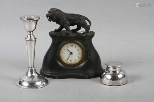 A pewter cased mantel clock with a lion surmount, a silver i...