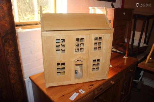 A modern dolls house with furniture and accessories, 25 wide...