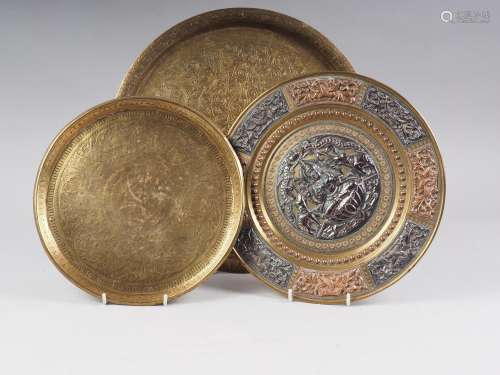 An Indian brass, copper and white metal mounted dish with re...