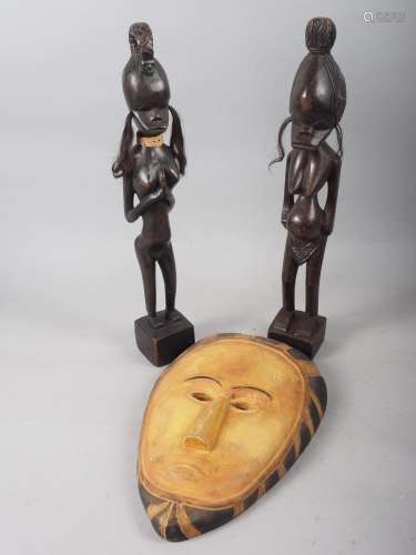 Two African fertility figures, 19 high, and a similar carved...