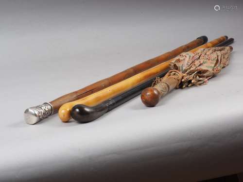 A Chinese white metal mounted bamboo walking stick, an eboni...