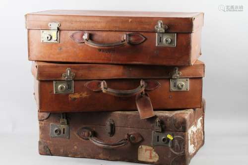 A pair of early 20th century leather bound suitcases, stampe...