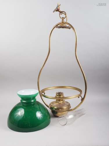 An early 20th century brass hanging oil lamp with green glas...