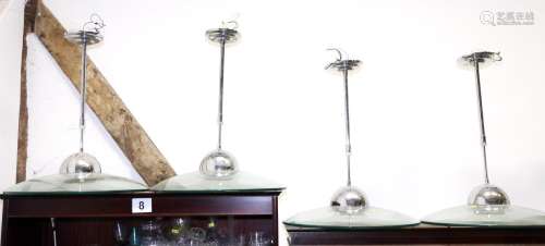 A set of four chrome and glass adjustable ceiling pendants