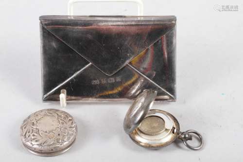 An engraved silver plated sovereign case, a silver envelope ...
