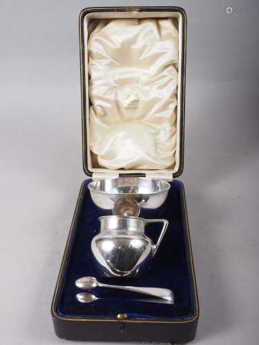 A silver sugar bowl, milk jug and sugar tongs, in fitted cas...